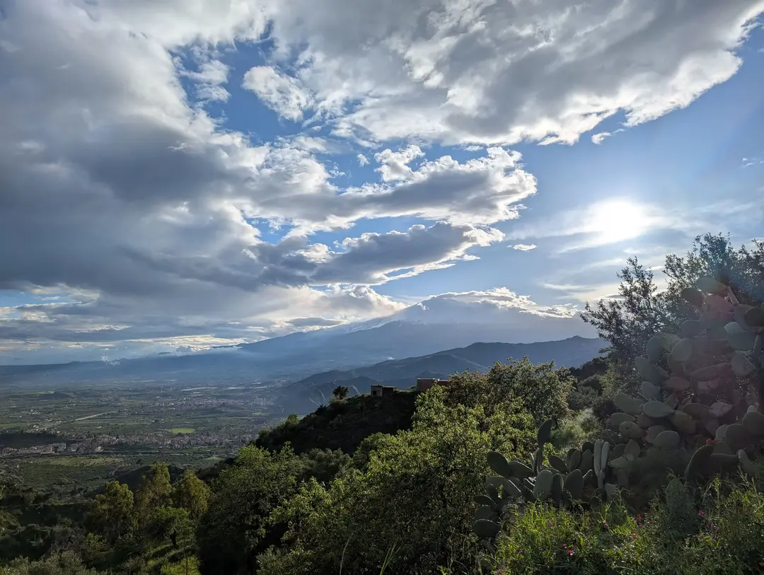 Mount Etna peaking out from beneath the clouds