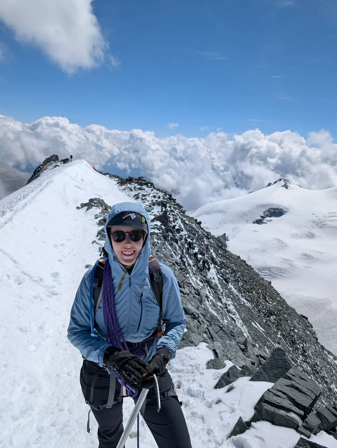 On the summit ridge with clouds on the horizon.